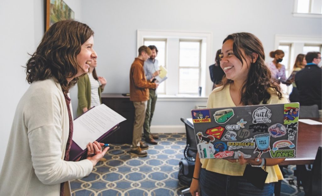 Student and teacher talking in classroom